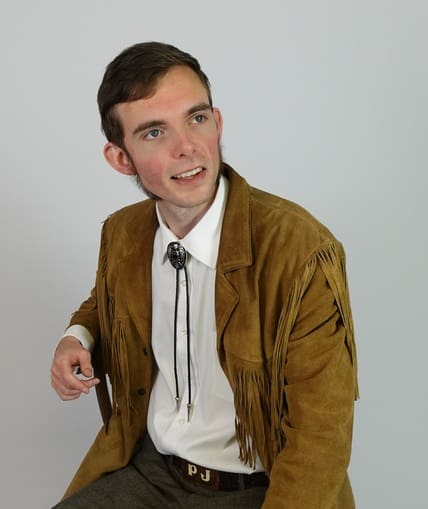 A performer sat down looking to their left