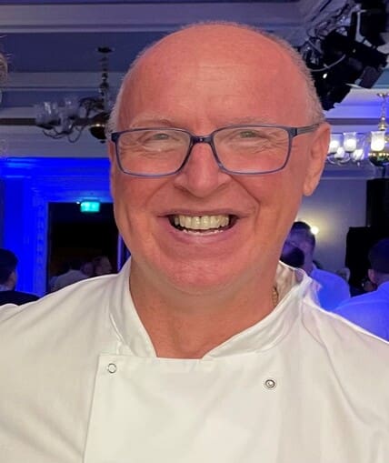 Head shot of a man stood at an event smiling