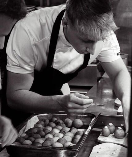 Young chef adding finishing touches to a restaurant dish