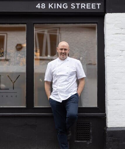Chef stood outside building in their chef whites