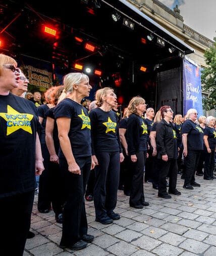 A choir performing at the main music stage during a popular food and drink festival