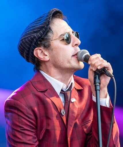 Performer singing into a microphone on a stage