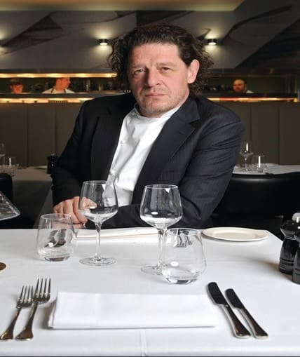 A man sat at a dinner table in a restaurant