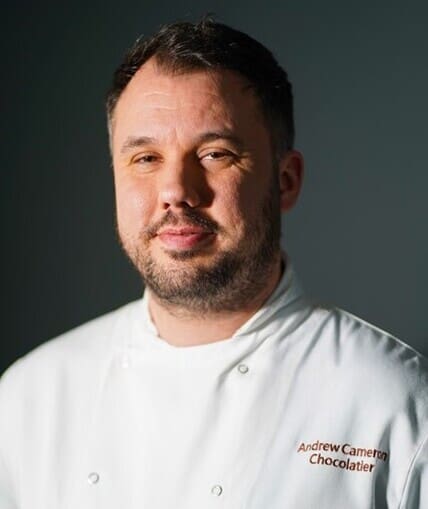Professional choclatier taking a picture in their chef whites