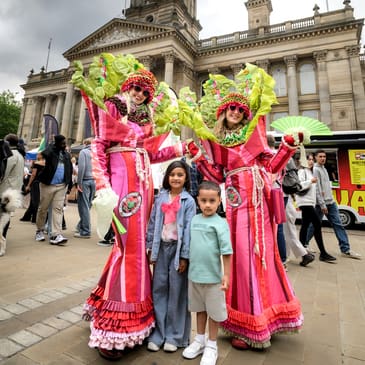 Street entertainers posing for an image with 2 children at BFDF 2025