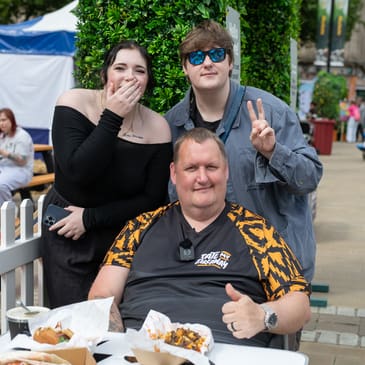 Social media influencer getting a photograph with 2 People at BFDF 2025