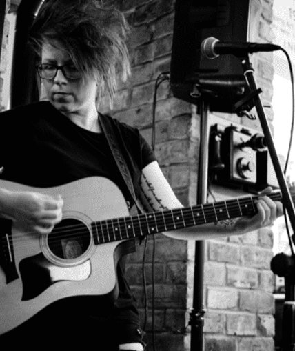 Musical performer on stage with guitar