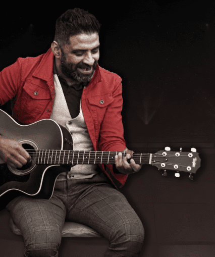 Musical performer on stage with guitar